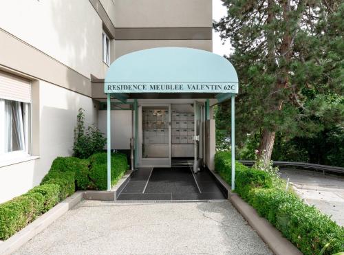 an entrance to a building with a sign on it at Modern apartments in the heart of Lausanne in Lausanne