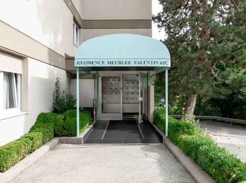 an entrance to a building with a sign on it at Modern studios in the heart of Lausanne in Lausanne