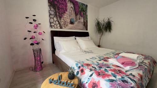 a bedroom with a bed and a vase with flowers at Villa Zigana in Mostar