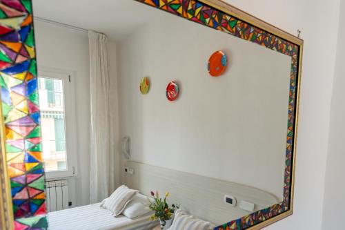 a mirror on the wall of a room with a bed at Maiori Apartment by Marcel in Maiori
