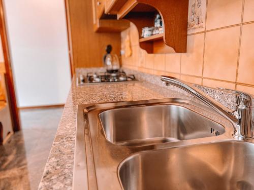 a stainless steel sink in a kitchen at Villa Nadya by GardaDoma in Brenzone sul Garda
