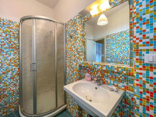 a bathroom with a sink and a shower at Casa Caretta con terrazza panoramica in Isola del Giglio