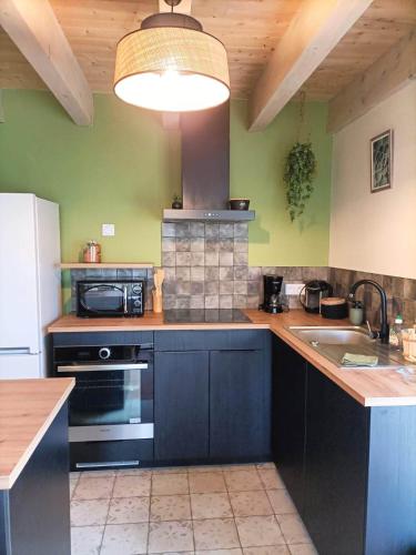 a kitchen with a sink and a stove top oven at Havre de Paix 40 in Pouillon