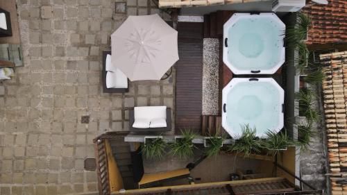 an overhead view of a bathroom with a toilet and an umbrella at Pousada Juannas Buzios in Búzios