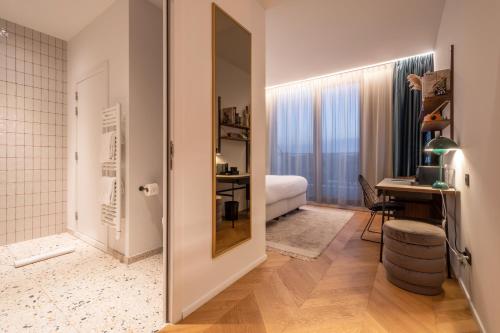 - une chambre avec un lit et un bureau dans l'établissement Yalo Urban Boutique Hotel Gent, à Gand