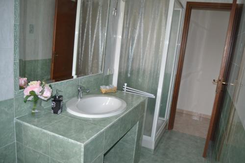 ein Bad mit einem Waschbecken und einem Spiegel in der Unterkunft Appartamento Il Volo in Lippo di Calderara di Reno