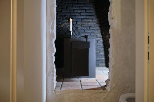 a room with a candle and a brick wall at Haus Fünf mit 2 Apartments und Studio-Loft mit Terrasse in Melk