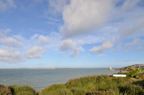 a view of a body of water with a cloudy sky at 2 Brambles Farm Holiday Bungalow in Freshwater