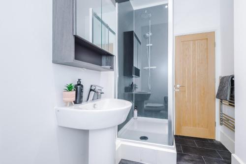 a bathroom with a sink and a shower at Guestz The Old Embassy Apartments in Hull