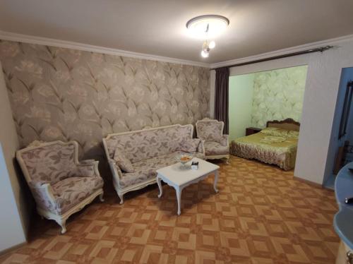 sala de estar con sofá, mesa y cama en Квартиры посуточно и помесячно в городе Гюмри, Армения en Gyumri