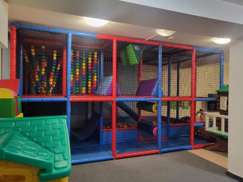 a play room with a large cage with toys in it at Willa Skałka in Białka Tatrzanska