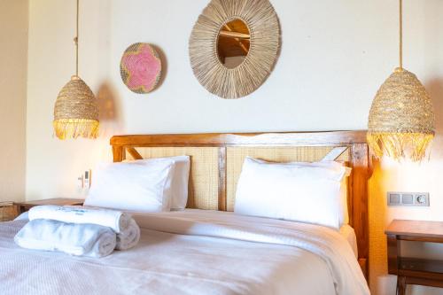 a bedroom with a bed with towels on it at La Boheme Kabak Adults Only in Faralya