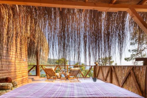 a room with a table and chairs on a patio at La Boheme Kabak Adults Only in Faralya