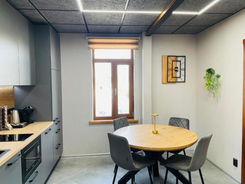 a kitchen with a table and chairs in a room at BRIVIBAS RESIDENCE - EAST / WEST, free PRIVAT parking, free WIFI, self check-in in Rīga