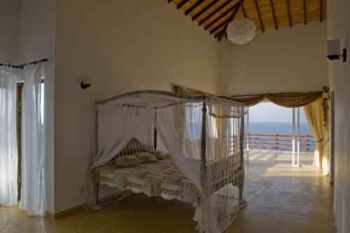 a bedroom with a bed with a view of the ocean at Land's End Villa in Unawatuna