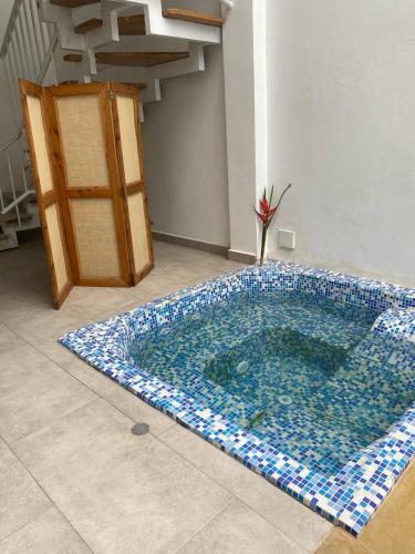 a swimming pool in the middle of a room at Hotel Boutique Iyarí in Palmira