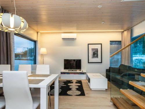 a living room with a dining table and a couch at Holiday Home Villa joutseno by Interhome in Imatra