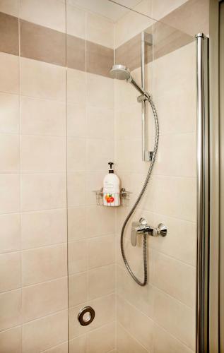 a shower with a shower head in a bathroom at Pepleri Studio 29 in Tartu