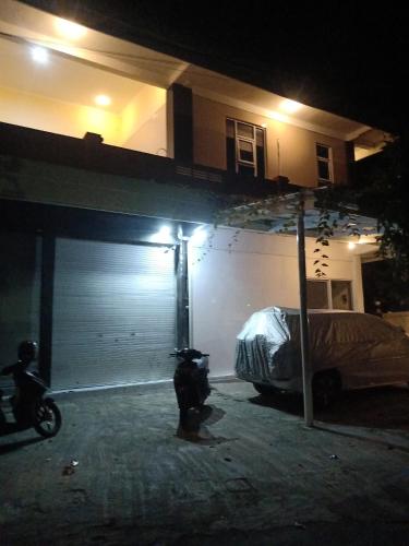 a garage at night with a parking meter and a car at Ubud Suites Batuan in Sukawati