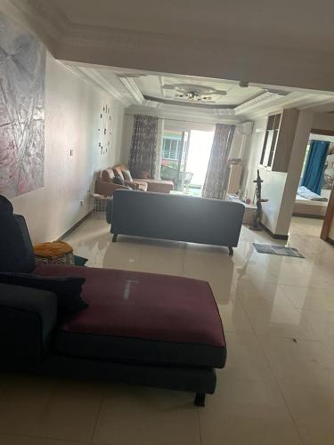 a living room with a couch and a living room with a couch at saveliving in Dakar
