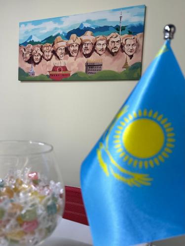 a blue vase sitting on a table with a flag at Hostel O2 in Almaty