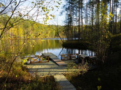 a wooden bridge over a body of water at Holiday Home Villa tunturitervakko by Interhome in Ylämylly