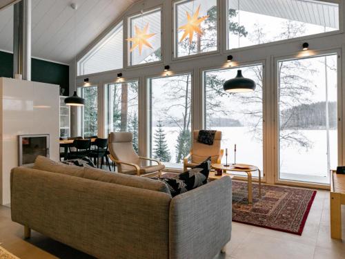 a living room with a couch and a table at Holiday Home Villa honkarinne by Interhome in Jyväskylä