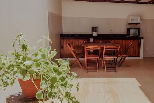a kitchen with a table and chairs and a dining room at Familia Pansini casa na Pipa in Pipa
