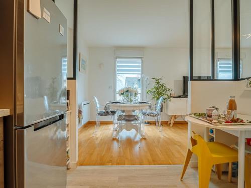 a kitchen and dining room with a table and chairs at Apartment Les Rives de la Rance by Interhome in La Richardais