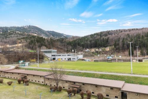 a building with a field and a soccer field at FarawayHomes Studio Leoben #P71 in Donawitz