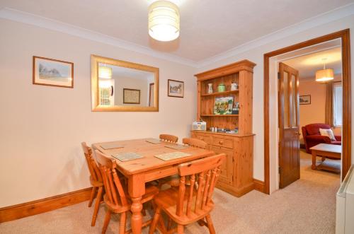 a dining room with a wooden table and chairs at The Bays in Bowcombe