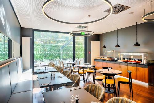 a restaurant with tables and chairs and a large window at Premier Inn Frankfurt City Europaviertel in Frankfurt/Main