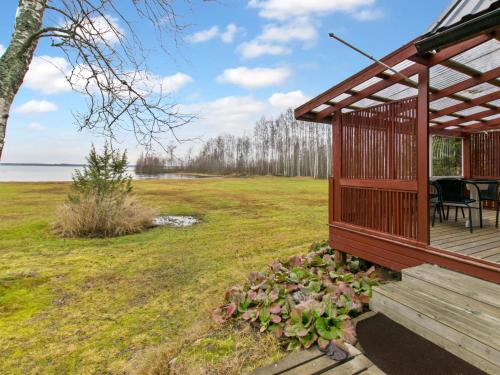 a house with a deck with a table and chairs at Holiday Home Missi by Interhome 