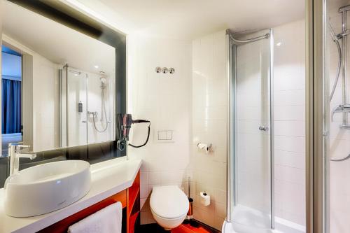 a bathroom with a sink and a shower at Premier Inn Frankfurt City Europaviertel in Frankfurt/Main