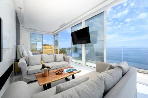 a living room with a couch and a tv at Ray Hotel Corfu in Perama