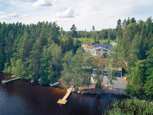 an aerial view of a house in the middle of a river at Holiday Home Vapunkärki by Interhome in Orivesi