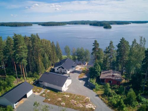 an aerial view of a house on the shore of a lake at Holiday Home Vapunkärki by Interhome in Orivesi