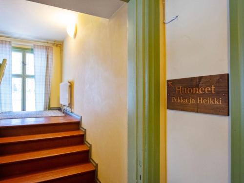 a sign on the wall of a hallway with stairs at Holiday Home Kartanohuoneisto pekka by Interhome in Runni