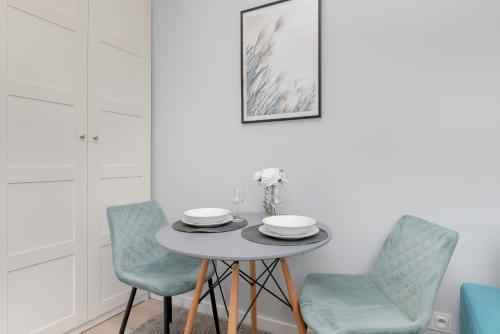a dining room with a table and two chairs at Cosy Studios near the Old Town in Gdańsk by Renters in Gdańsk