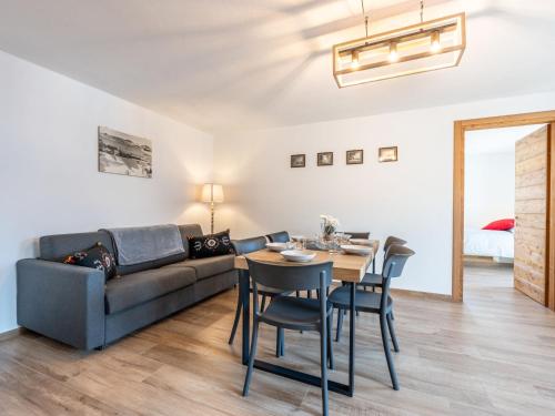 a living room with a couch and a table and chairs at Apartment I tre Corvi by Interhome in Prali