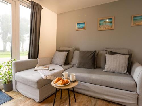 a living room with a couch and a table at Chalet Wheal Tor Lodge by Interhome in Helston