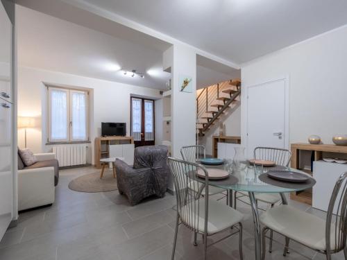 a dining room and living room with a table and chairs at Holiday Home Louna by Interhome in Mergozzo