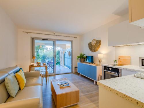 une cuisine et un salon avec un canapé et une table dans l'établissement Apartment Les Calanques de boulouris by Interhome, à Saint-Raphaël