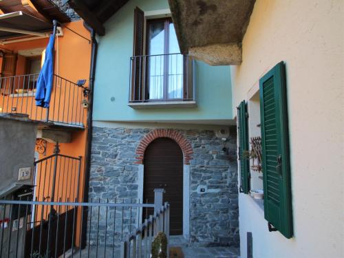 an entrance to a house with a door and a balcony at Holiday Home Silvia by Interhome in Mergozzo