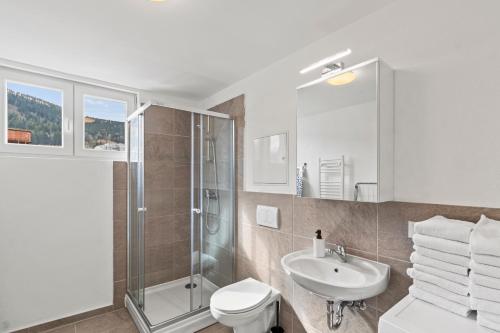 a bathroom with a shower toilet and a sink at StayEasy Apartments Leoben P88 #12 in Donawitz