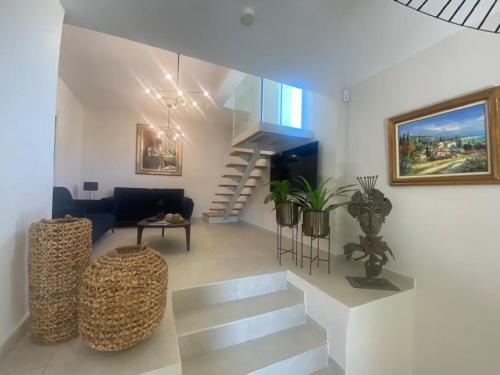 uma sala de estar com uma escada em espiral e uma sala de estar em Villa Villa Vallon d'Aiguebelle by Interhome em Le Lavandou