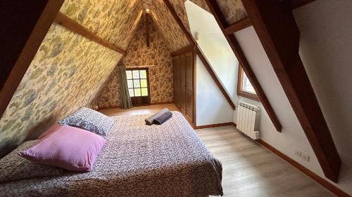 a bedroom with a bed in a room with a roof at Domaine Rêve Normand Honfleur 10 pax in Genneville