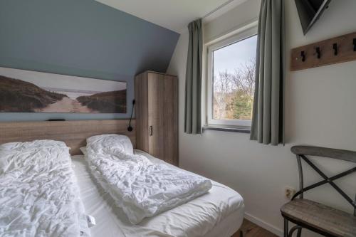 a bedroom with a bed and a window at Nieuwlanderweg 77 in De Waal