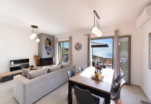 a living room with a couch and a table at Athanion Sunset House in Athani