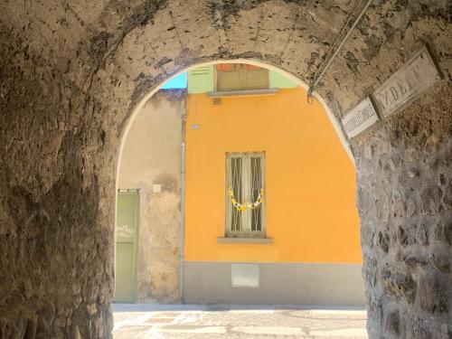 an archway in a building with an orange wall at In centro a due passi dal lago in Iseo